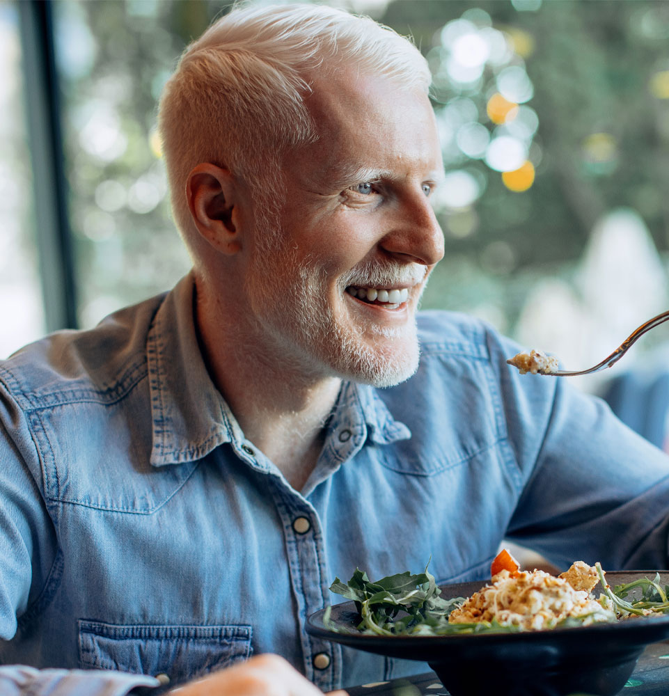 dental implant patient enjoying meal with confidence