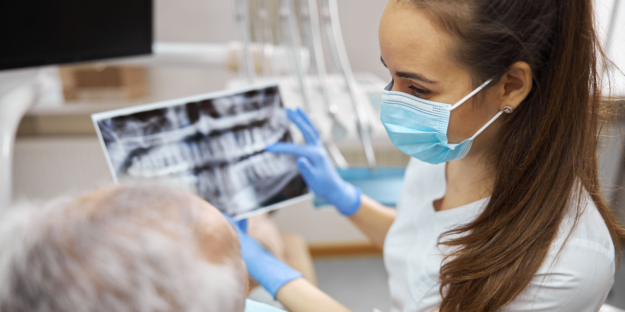 dentist with patient showing xray